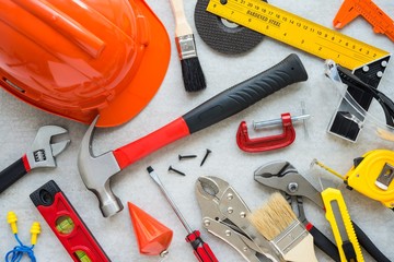 Flat lay, set of construction hardware tools building, repair, painting accessories on concrete board background