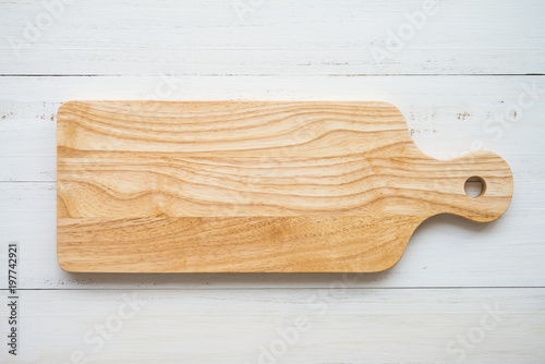 Fotomural Top view of unused brand new brown handmade wooden cutting board on white wooden
