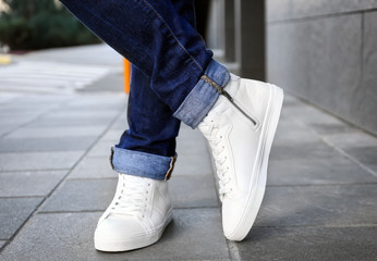 Canvas Print - Stylish man in white shoes on city street