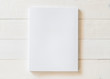Blank A4 size book cover mockup template with page front side on white surface on wood table