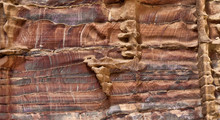 Laminated Sandstone In Petra, Jordan, With Strong Red, Yellow, Orange And Brown Colours