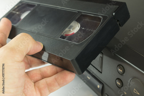 Fotomural insert a video cassette into a video recorder