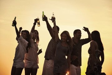 Group of young people enjoy summer  party at the beach