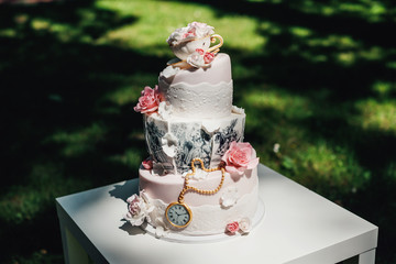 Wall Mural - White wedding cake decorated with crystals and glaze bow