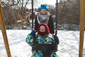 Child on swing in winter