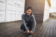 © Flamingo Images - Young Asian woman tying her running shoes before a run