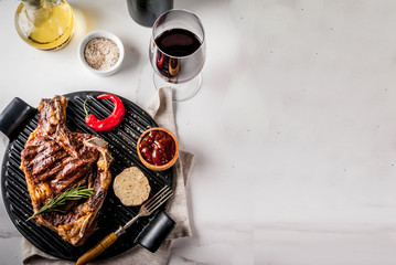 Wall Mural - Fresh grilled meat beef steak with with red wine, herbs and spices. Top view copy space white marble background