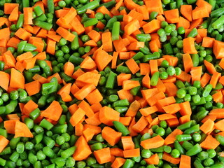 Sliced vegetables before baking on the Pan for baking. Carrots, green peas, green beans. The concept of a healthy diet.