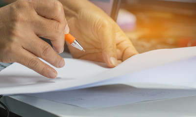 Businessman hands working in Stacks of paper files for searching information on work desk office, business report papers,piles of unfinished documents achieves with clips indoor,Business concept