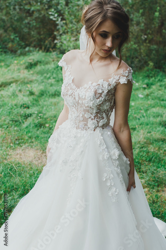 Beautiful Bride With Elegant Simple Hairdo Is Standing In The