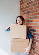 © Masson - redhead girl with a box in move out day.
