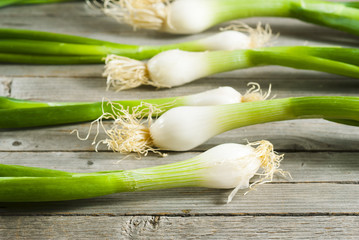 Wall Mural - Spring onions on old wooden table