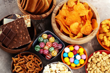 Salty snacks. Pretzels, chips, crackers in wooden bowls.