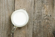 Milk jug on old wooden table