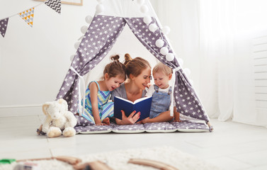 Sticker - family mother reading to children book in tent at home.