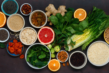 Poster - Clean eating concept. Flat lay vegetarian healthy food set -different vegetables and fruits, superfood, seeds, cereal, leaf vegetable on dark background, top view