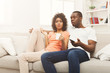 © Prostock-studio - Surprised black couple watching TV at home