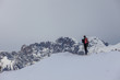 © Gianluca - Man on snowy crest that admires the Dolomite peaks, Col Visentin, Belluno, Italy
