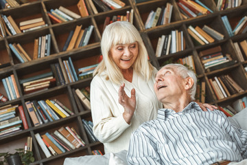 Wall Mural - Senior couple together at home retirement concept surprised