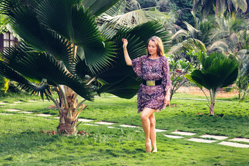 Wall Mural - Girl on the background of a palm tree.