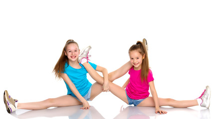 girls gymnasts perform exercises on twine.