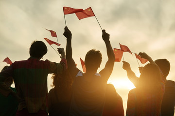 Wall Mural - Group of people waving chineese flags. People raising chineese flags up to the sky.