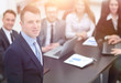 © ASDF - project Manager on the background of business team