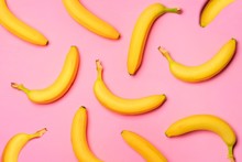 Colorful Fruit Pattern With Bananas Over A Pink Background. Top View.