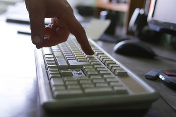 the man's hand touches the keyboard.