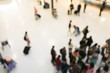 © narin_nonthamand - blurred image of crowd of travelling people or passenger walking with a luggage from flight in the international airport terminal with beautiful bokeh from the light,advertise & traveling concept.