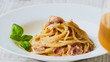 © Felix - spaghetti carbonara on white palte with basil leaf