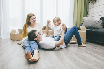 Wall Mural - Family together happy young beautiful with a little baby moves with boxes to a new home