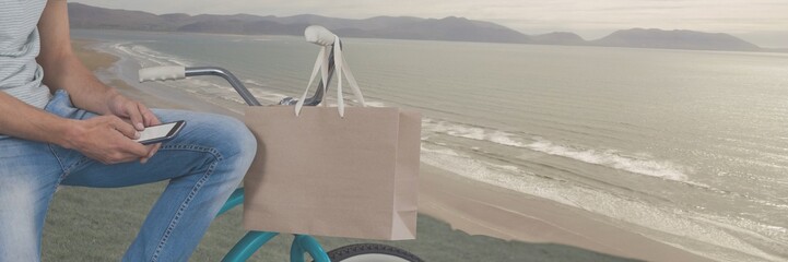 Poster - Travelling man with bicycle in front of sea landscape