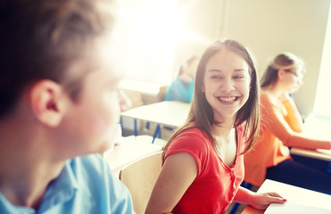 Poster - education, learning, communication and people concept - group of happy students talking at school break