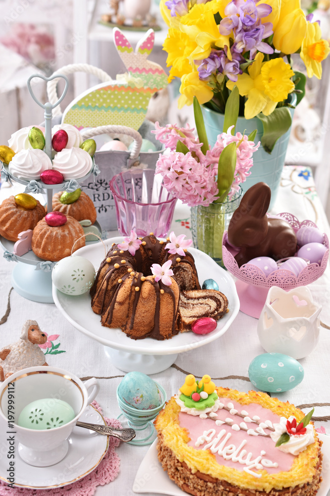  festive table decoration with traditional easter pastries and confectionery - obrazy, fototapety, plakaty 