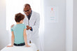 © Viacheslav Yakobchuk - Annual examination. Handsome positive male doctor standing while using stethoscope and treating boy