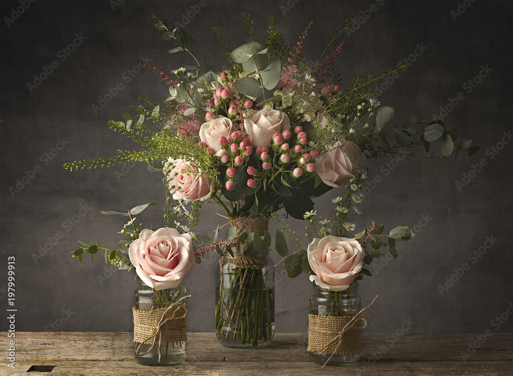 Rustic Fresh Roses Bouquets of roses in jam jars on a rustic wooden table Stock Photo ...
