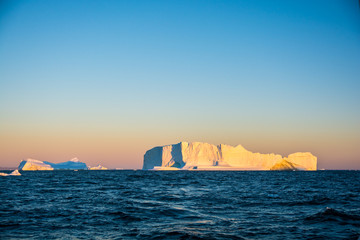 Wall Mural - big icebergs in sunrise. greenland's view.