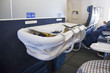 Baby sleeping in bassinet on airplane