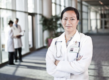 Asian Woman Doctor In Lab Coat With Stethoscope.