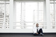 © Mint Images - Black man doctor stressed out and sitting on floor.