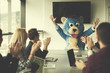 © .shock - boss dresed as bear having fun with business people in trendy office