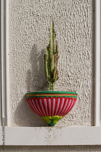 Cactus In A Hanging Pot On The Wall Of House Colored Pots Cactus In A Hanging Pot On The Wall Of House Colored Pots Mexican
