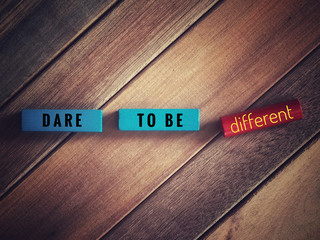 Motivational and inspirational quotes - Dare to be different. With vintage styled background.