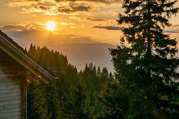 Austrian lodge at dusk in the forest mountains