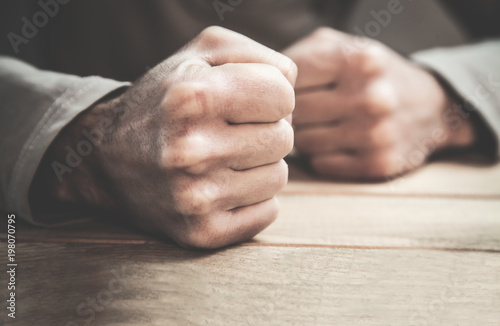 Cuadros en Lienzo Angry man fists in the table.