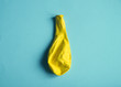© ksuklein - Deflated yellow balloon on blue background