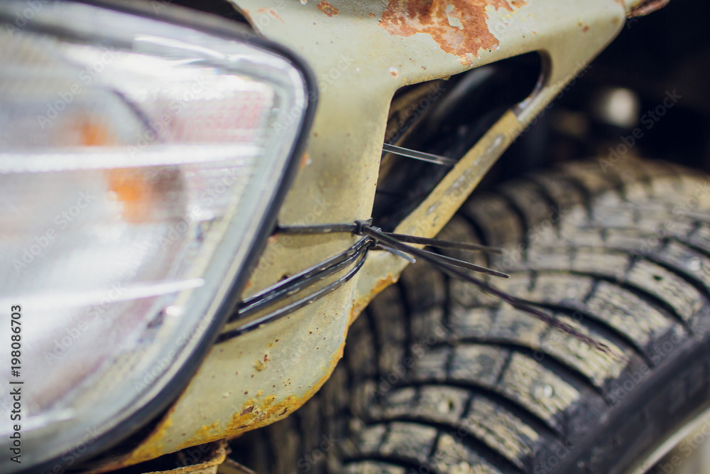 Old and rusty car's suspension, which removes the wheels for repair ...