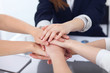 © rogerphoto - Close Up of unknown business people joining hands. Teamwork, cooperation and success concept of people communication