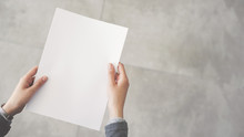 Person Holding White Empty Paper